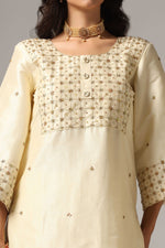 Load image into Gallery viewer, Creme raw silk gold zari embroidered & hand crafted with sequence kurti paired with pants and a net dupatta