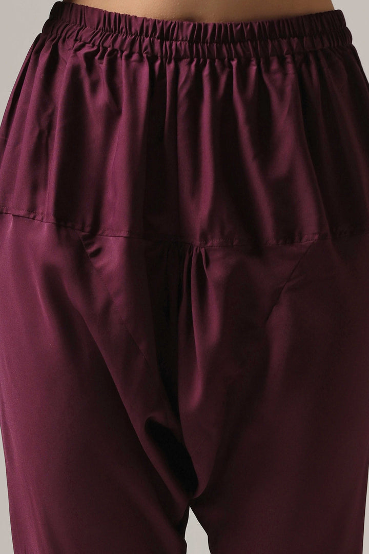 Purple raw silk machine embroidered anarkali paired with churidar and a matching net dupatta.