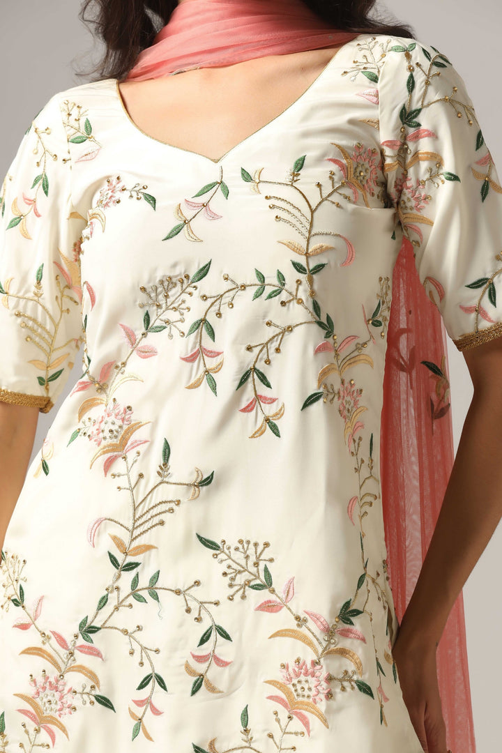 Cream-colored French crepe sharara set with multi-color resham embroidery with net dupatta