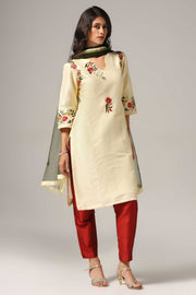 Creme raw silk embroidered kurti paired with pants and a net maching dupatta.
