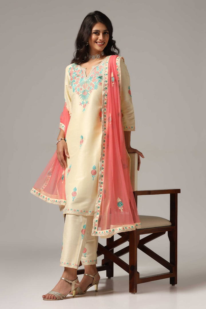 Creme raw silk ari embroidered kurti paired with pants and a net maching dupatta