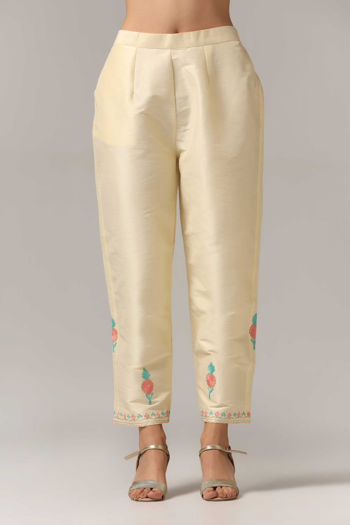 Creme raw silk ari embroidered kurti paired with pants and a net maching dupatta