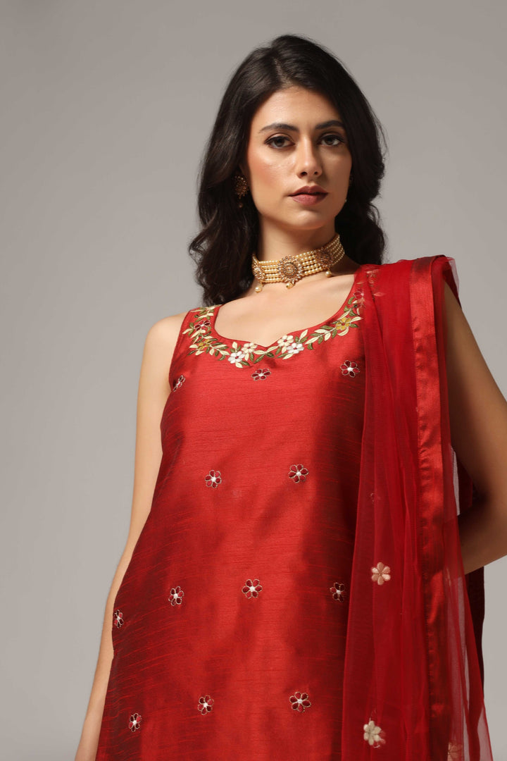 Maroon raw silk sharara set adorned with multi-color resham embroidery, paired with a match net dupatta