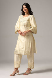 Creme raw silk gold zari embroidered & hand crafted with sequence kurti paired with pants and a net dupatta