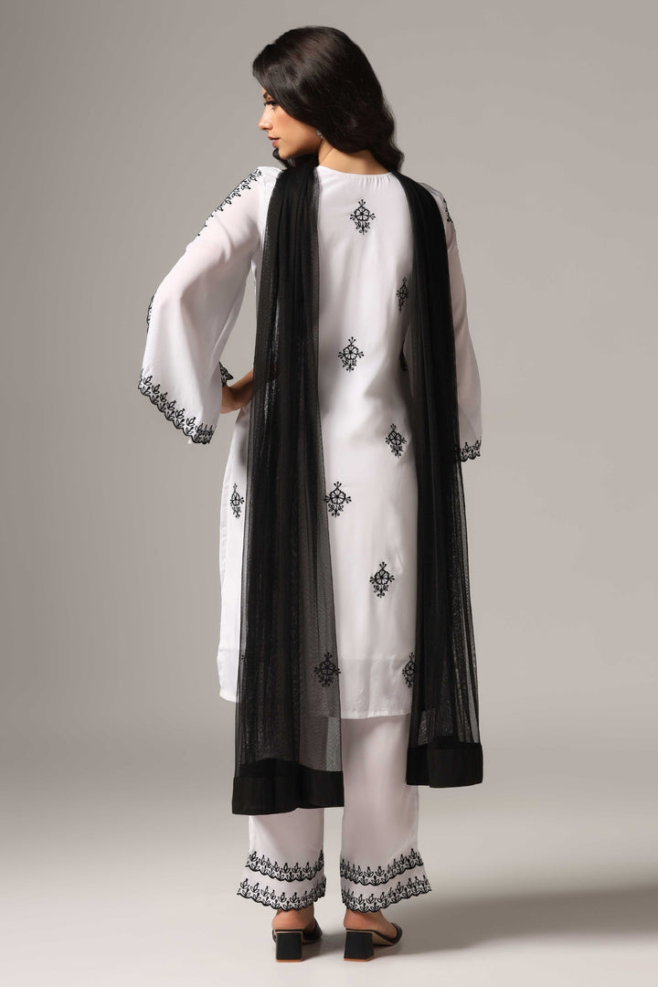 White french crepe resham embroidered kurti paired with pants and a net dupatta