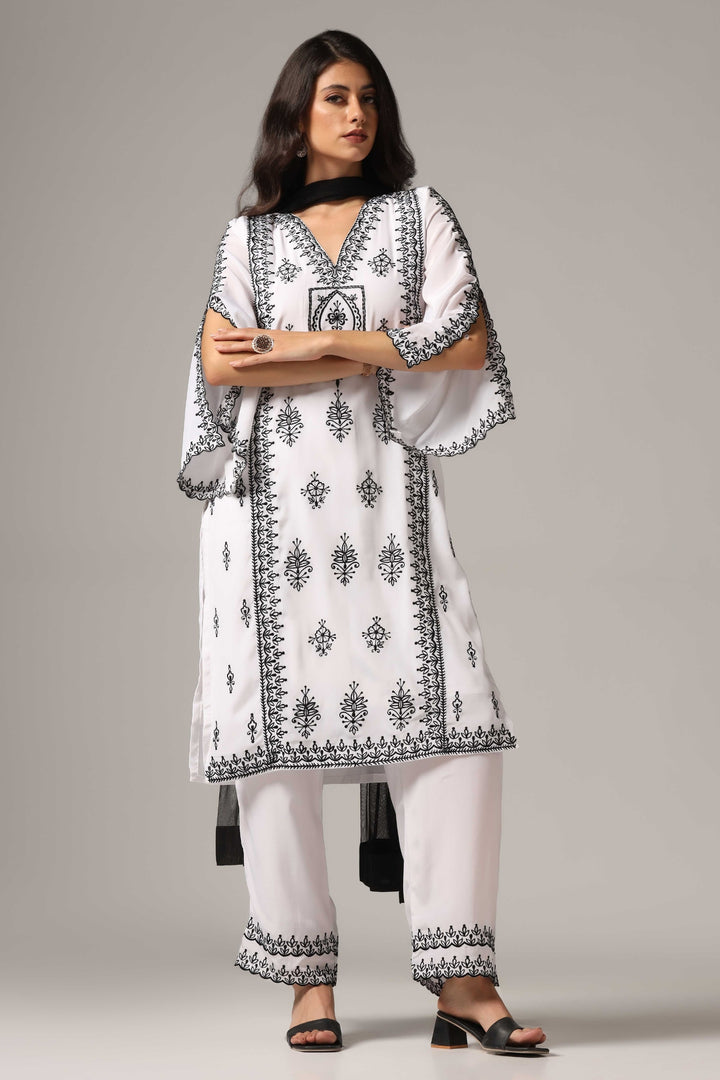 White french crepe resham embroidered kurti paired with pants and a net dupatta