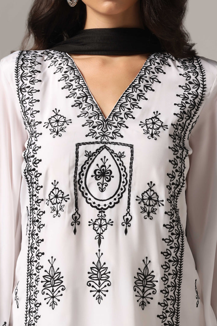 White french crepe resham embroidered kurti paired with pants and a net dupatta