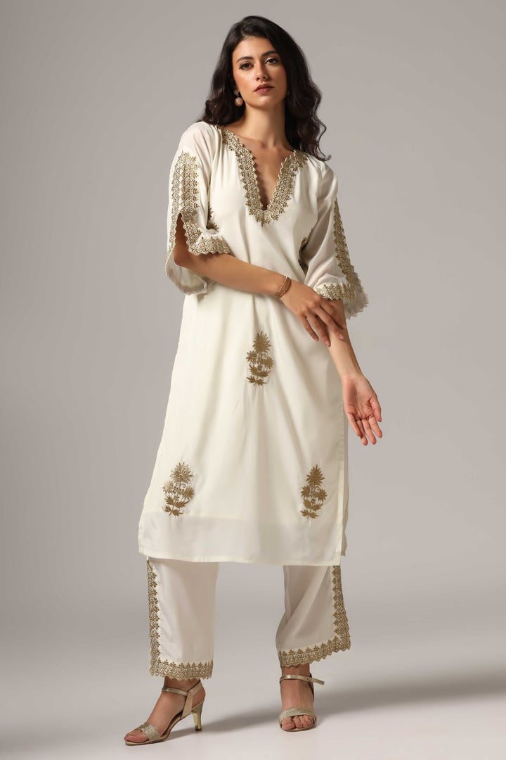 Creme french crepe gold zari embroidered kurti paired with pants