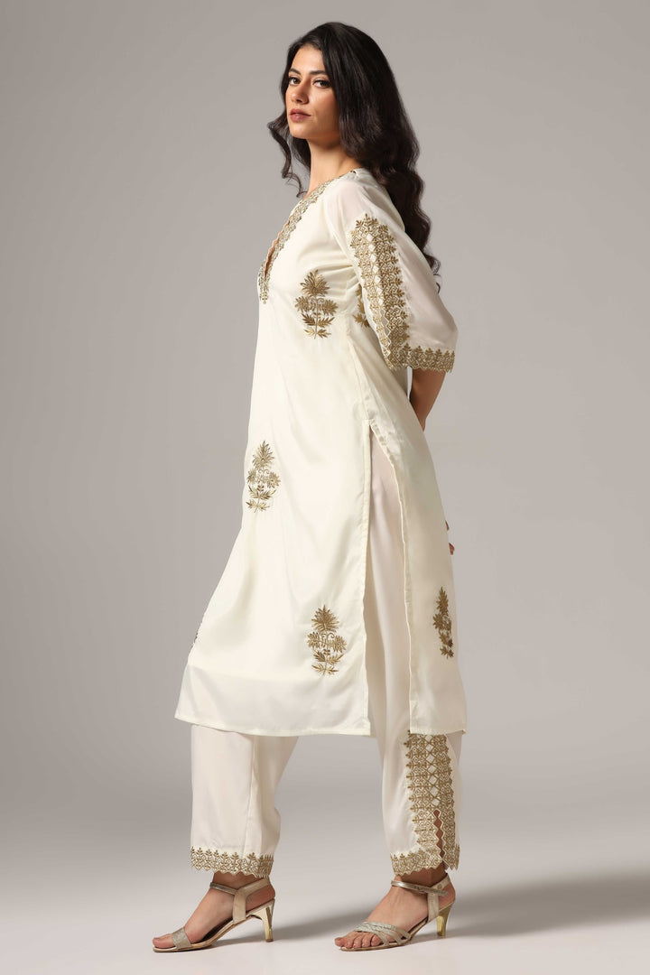 Creme french crepe gold zari embroidered kurti paired with pants