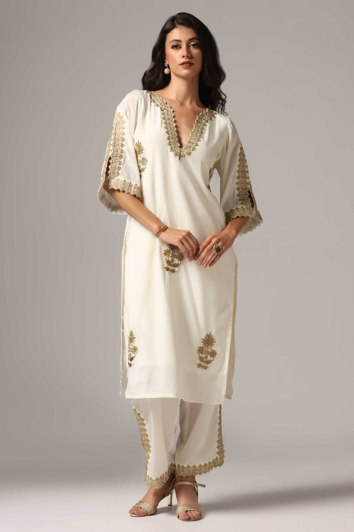 Creme french crepe gold zari embroidered kurti paired with pants