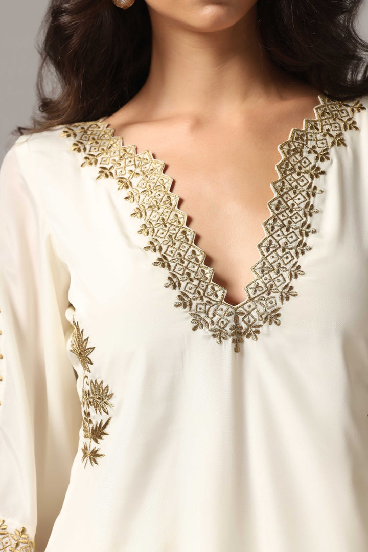 Creme french crepe gold zari embroidered kurti paired with pants