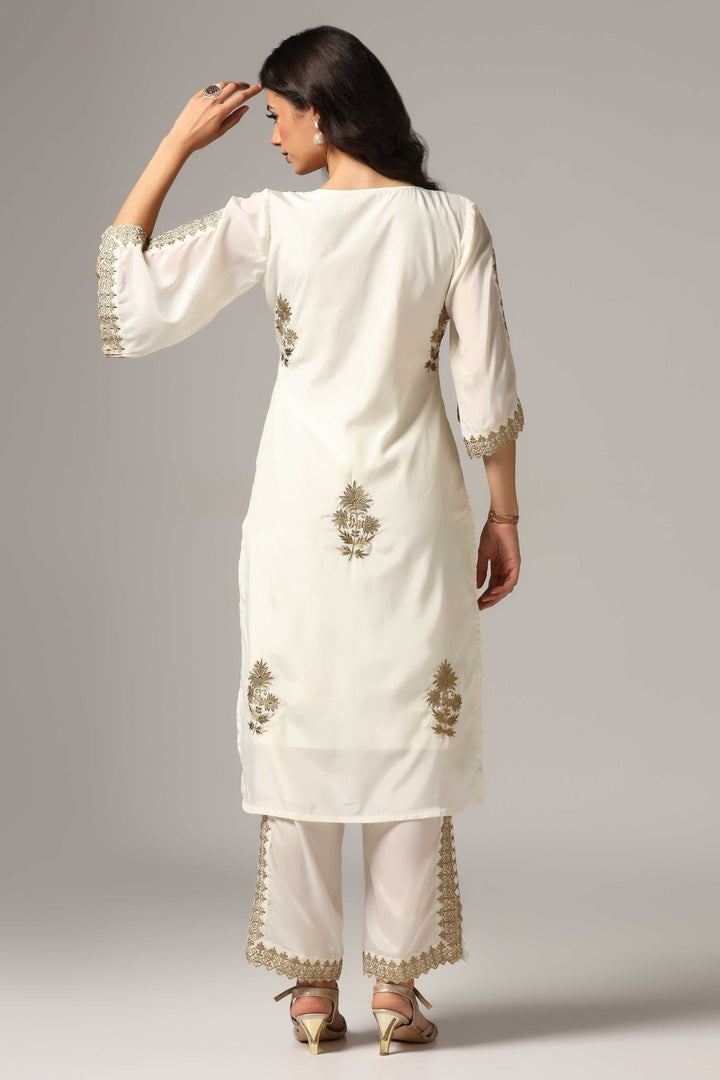 Creme french crepe gold zari embroidered kurti paired with pants