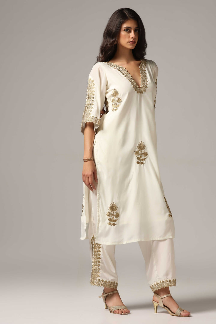 Creme french crepe gold zari embroidered kurti paired with pants