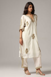 Creme french crepe gold zari embroidered kurti paired with pants