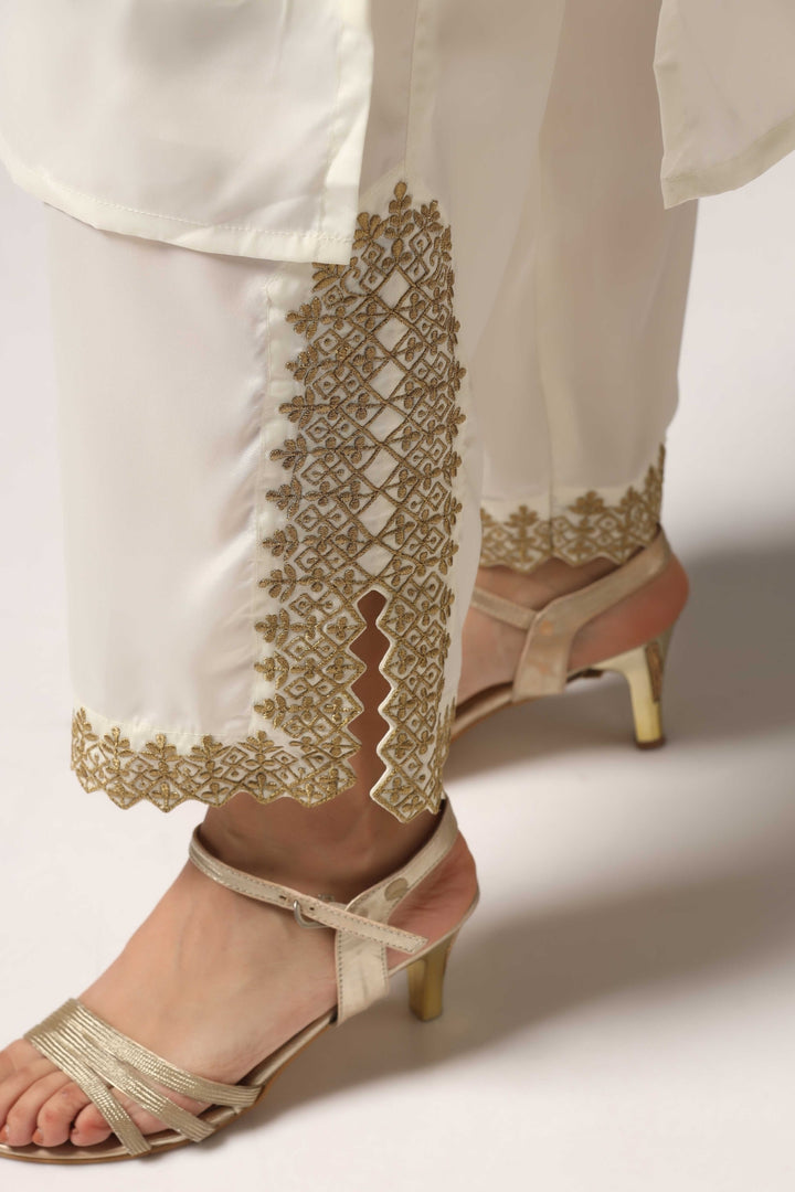 Creme french crepe gold zari embroidered kurti paired with pants