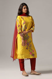 Yellow raw silk resham embroidered kurti paired with pants and a net dupatta